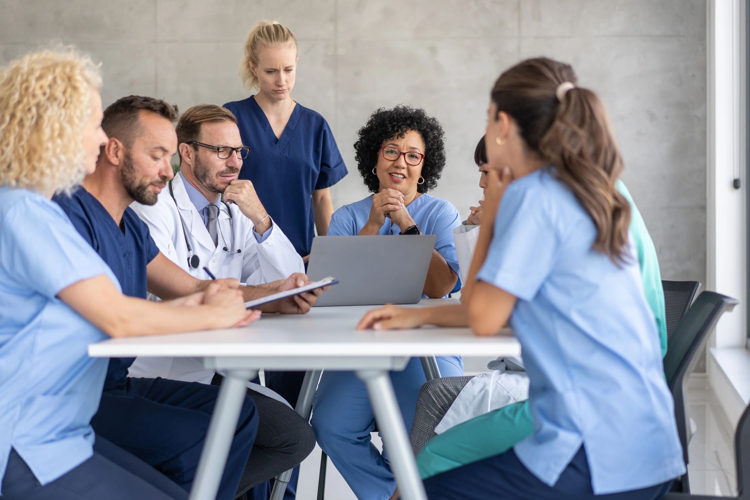 Professionals collaborating in a leadership meeting