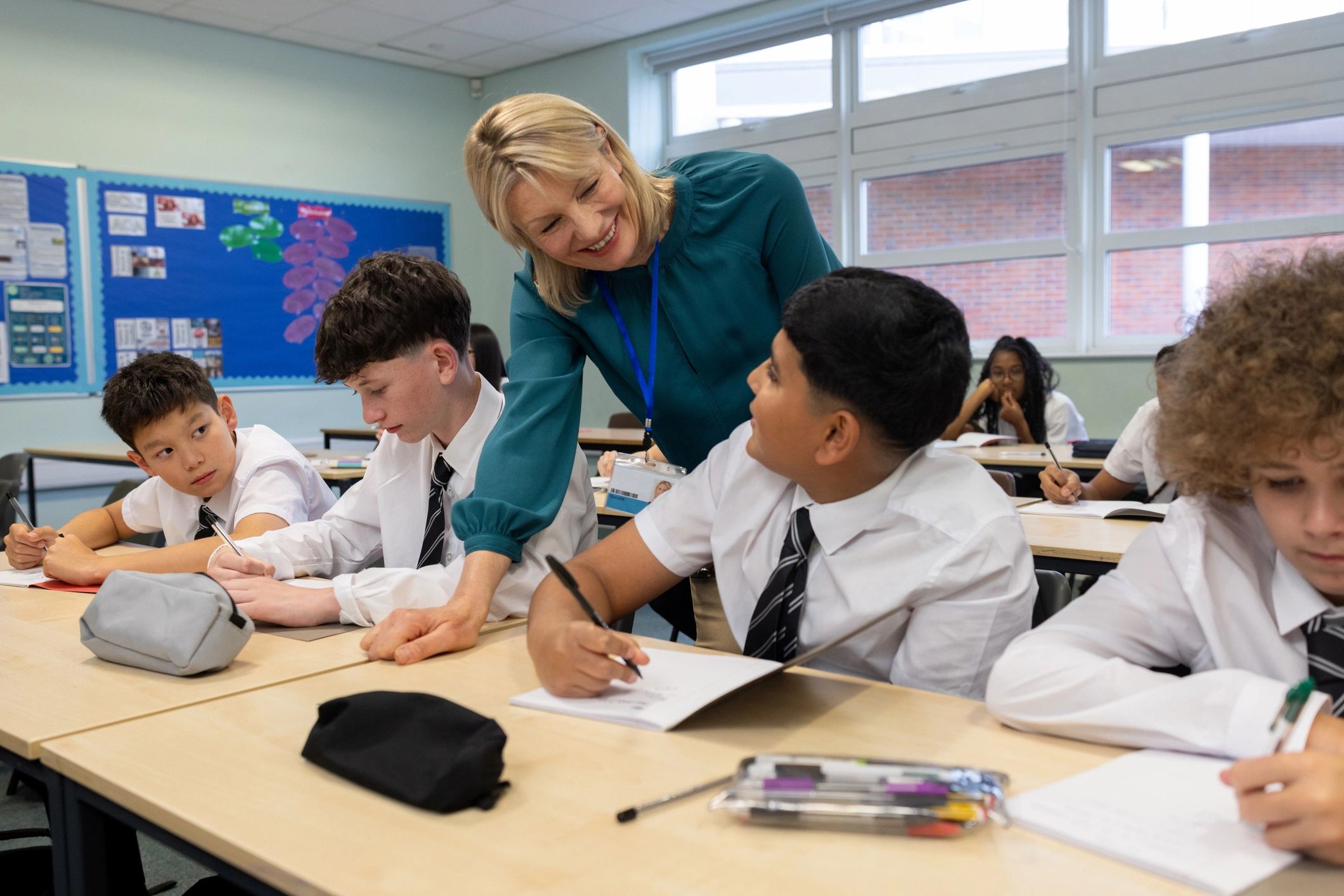 Teacher helping students in a classroom